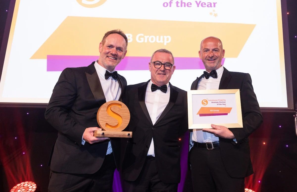 The AB Group team on stage with the Sainsbury's Property Strategic Partner of the Year trophy and certificate.