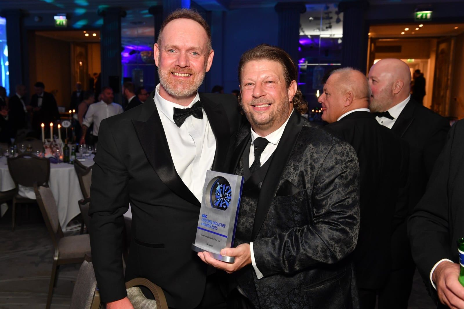 Two of the AB Group team with the RAC Cooling Industry Awards 2025 Heat Pump Project of the Year trophy.