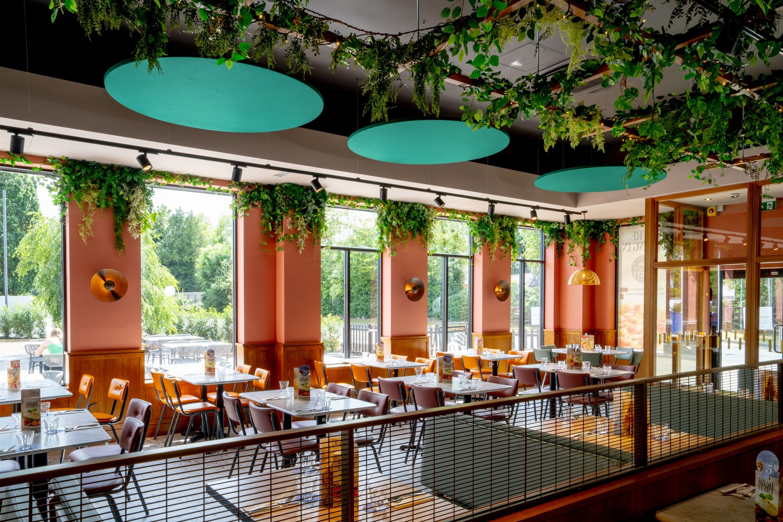 The finished Pizza Express dining room at Springfields, with feature ceiling rafts and full-height glazing.