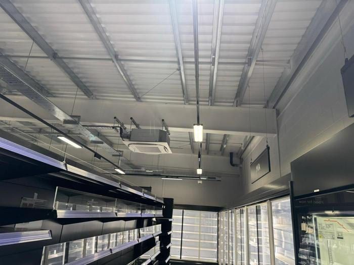 The unit during fit-out, with services and shelving being installed.