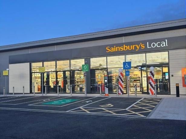 The completed Sainsbury's Local at Westwood Heath at dusk, seen from the car park.