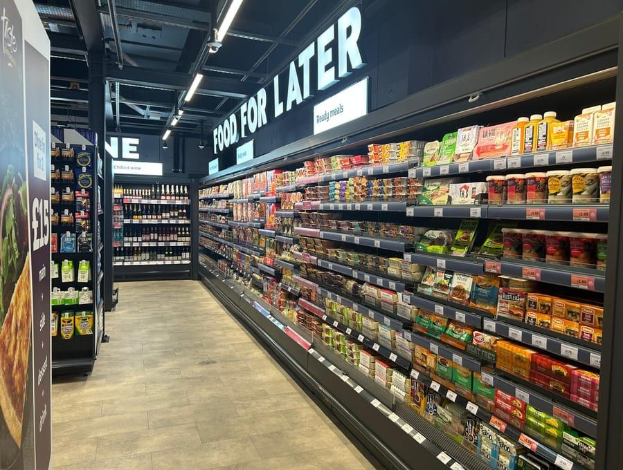 A run of efficient, well-lit refrigerated cabinets in a finished store.