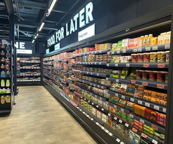 A refrigerated chilled aisle in a supermarket, stocked and lit.