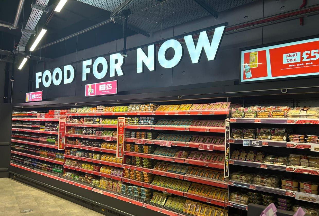 A run of efficient, well-lit refrigerated cabinets in a finished store.