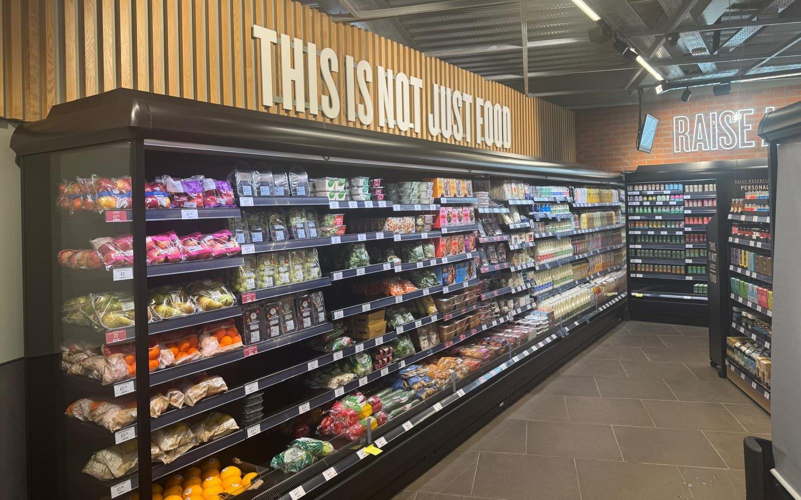 A lit run of chilled food cabinets in a finished M&S store.